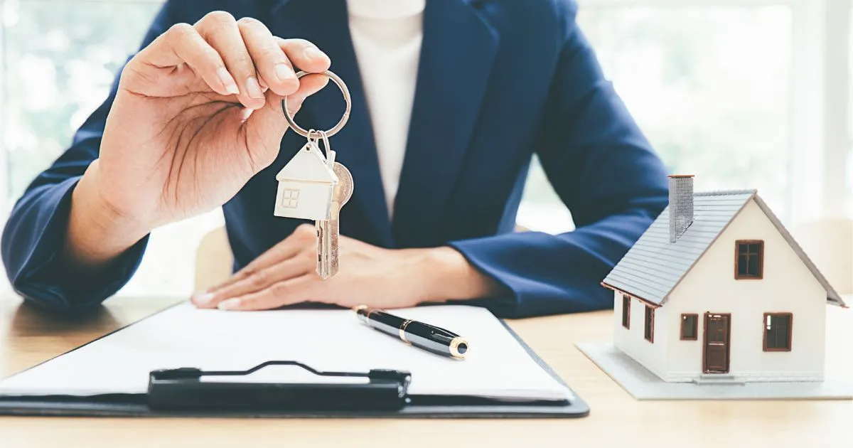 Realtor handing over house keys to a client during a home sale transaction