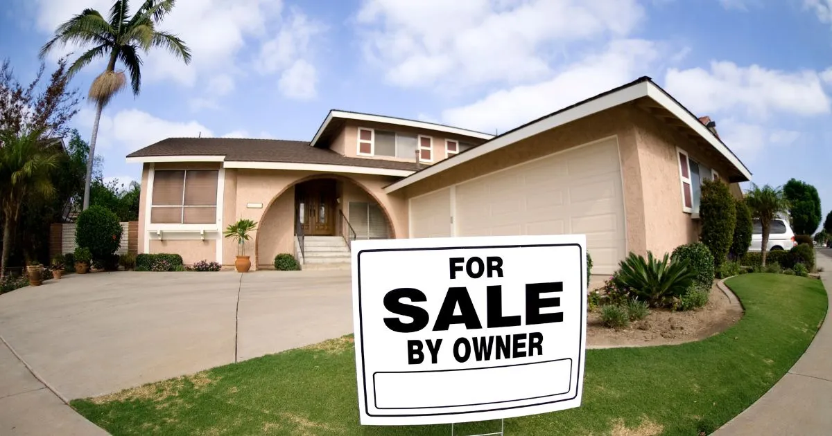 A house in Layton, UT with a FSBO Property sign displayed on the front lawn